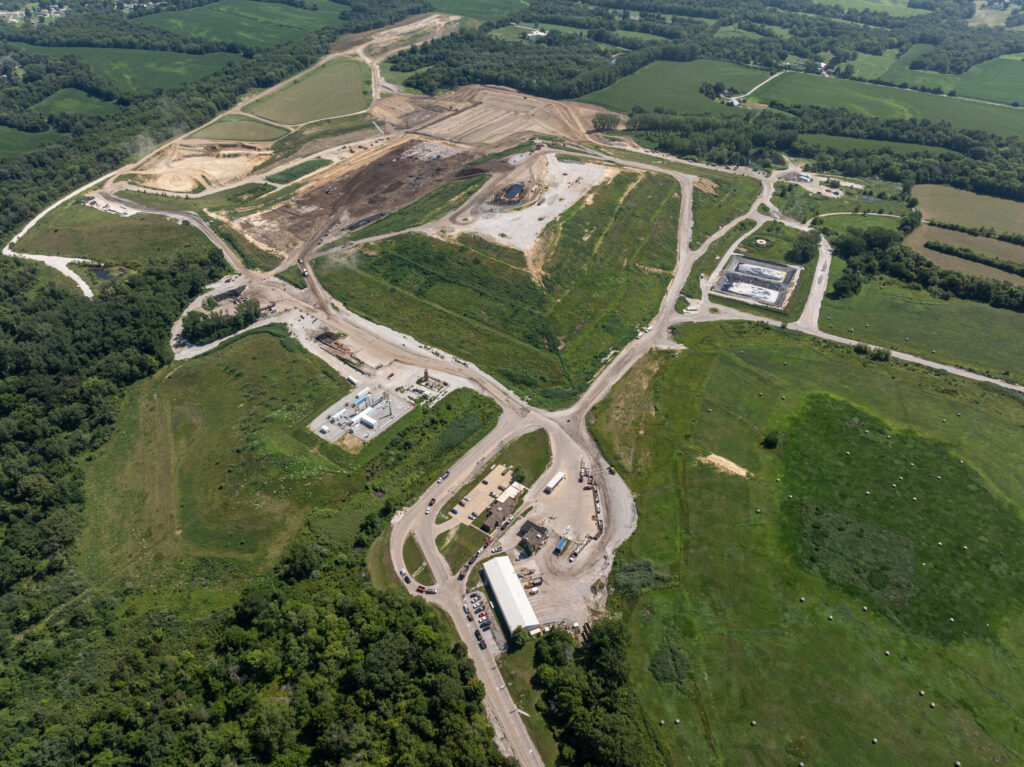 Ariel view of Scott Area Landfill showing wooded areas, roads, grass, landfill buildings, and landfill working face